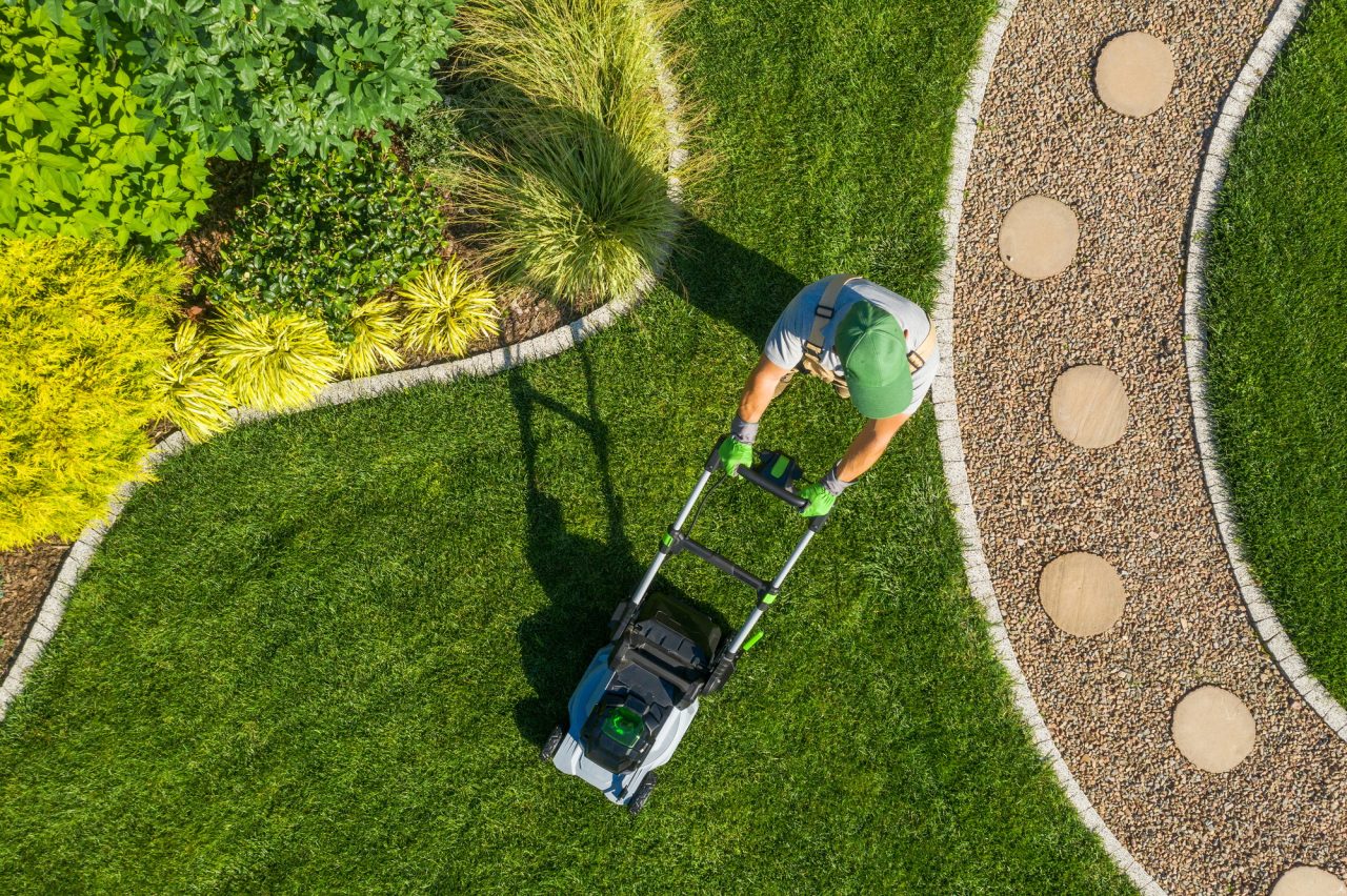 gardener-mowing-backyard-garden-grass-aerial-view-.jpg
